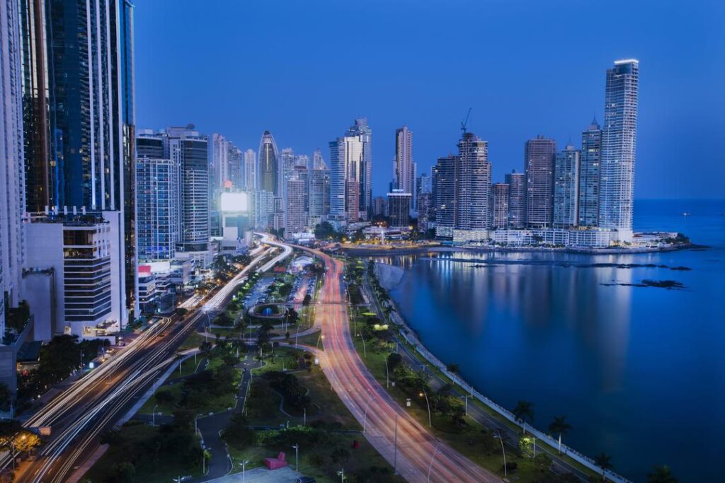 A vibrant cityscape of Panama City, the capital and largest city of Panama, captured from an aerial perspective. The image showcases the city's modern architecture, bustling urban life, and the Panama Canal, a crucial waterway that connects the Atlantic and Pacific Oceans. The city is surrounded by a lush tropical landscape, adding to its charm and allure.