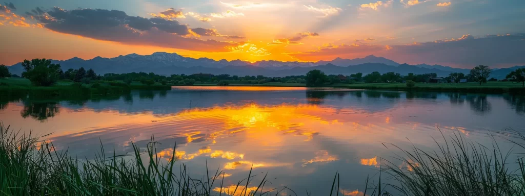 a vibrant sunset casts a golden glow over a tranquil lake, with majestic mountains reflecting perfectly on the water's surface.